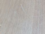 a close up of a wooden table with a knife on it
