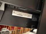 a close up of a computer monitor with a bar stool in the background