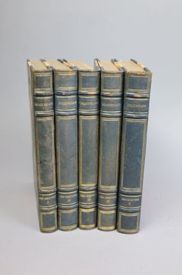 six blue books are lined up in a row on a white surface