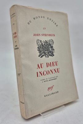 an old book sitting on top of a table next to a white table
