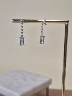pair of blue topaz blue topaz crystal earrings on a gold stand