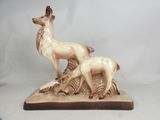 a statue of a deer and a baby deer on a rock
