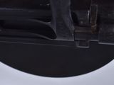 a close up of a toilet seat with a black handle