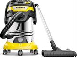 a yellow vacuum cleaner with a black hose next to it