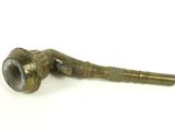 an old pipe sitting on top of a table next to a white background