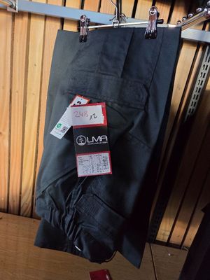 a black umbrella hanging on a clothes rack in a room