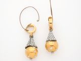 pair of gold and diamond earrings on a white background