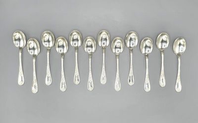six silver spoons are lined up in a row on a gray surface