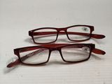 two pairs of glasses sitting on top of a box