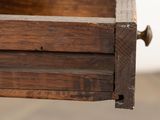 a close up of a wooden box with nails on it
