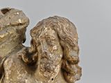 a statue of an angel with a bird on his shoulder