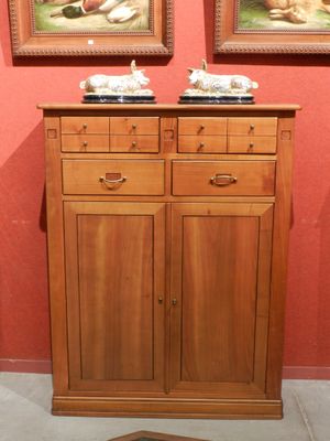 deux tableaux accrochés au mur au-dessus d'une armoire en bois