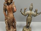 two bronze figurines of a man and a woman on a pedestal