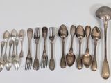 a lot of silver spoons and forks on the table