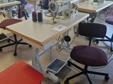 many sewing machines that are sitting in a room