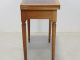a small wooden table with a drawer on it