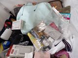 a pile of items in a plastic bag on a bed