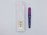 an image of a pen and a box of lipstick on a white surface