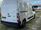 the white van is parked on the side of the road