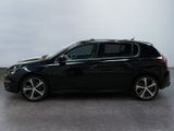 the black car is parked on the concrete floor in the room