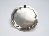 a silver plate with a flower design on it