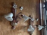 two wall sconces on the wall of a restaurant