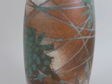 a brown vase with blue and green designs on it