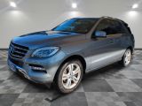 the mercedes mlx is parked in a garage with a checkered floor
