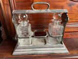 a silver tray with three glass bottles on top of it