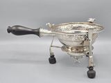 an antique silver plated coffee grinder with black handles and a wooden handle