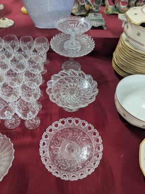 a table with a lot of glass plates and bowls on it