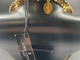 chandelier with a gold chain and a tag on a black mannequin