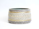 a close up of a silver and gold ring on a white background