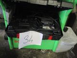 a green and black box with a charger on top of it