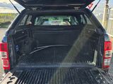 the back end of a pickup truck with its trunk open