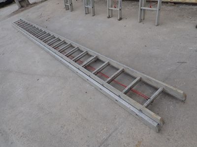 a ladder that is laying on the ground next to some chairs