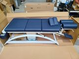 an image of a blue and white examination table in a warehouse