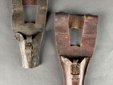 two pieces of wood and metal are sitting on a gray surface