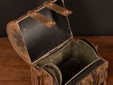 a small wooden box on a table with a black wall behind it