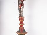 a statue of a man standing on top of a red pedestal