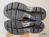 the soles of a pair of running shoes on top of a cardboard box
