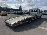 a flatbed truck that is parked in a parking lot