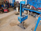 a blue workbench in a garage with tools on it