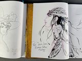 a book with a drawing of a woman in a hat