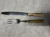two knives and a knife holder on a marble surface