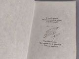 an open book with a drawing of a bird on it