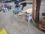 a miter saw that is sitting on a table in a garage