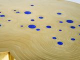 a gold table with blue dots on it