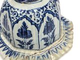 blue and white porcelain figurine with a bird on top of it