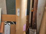 a large roll of cardboard sitting next to a pile of cardboard